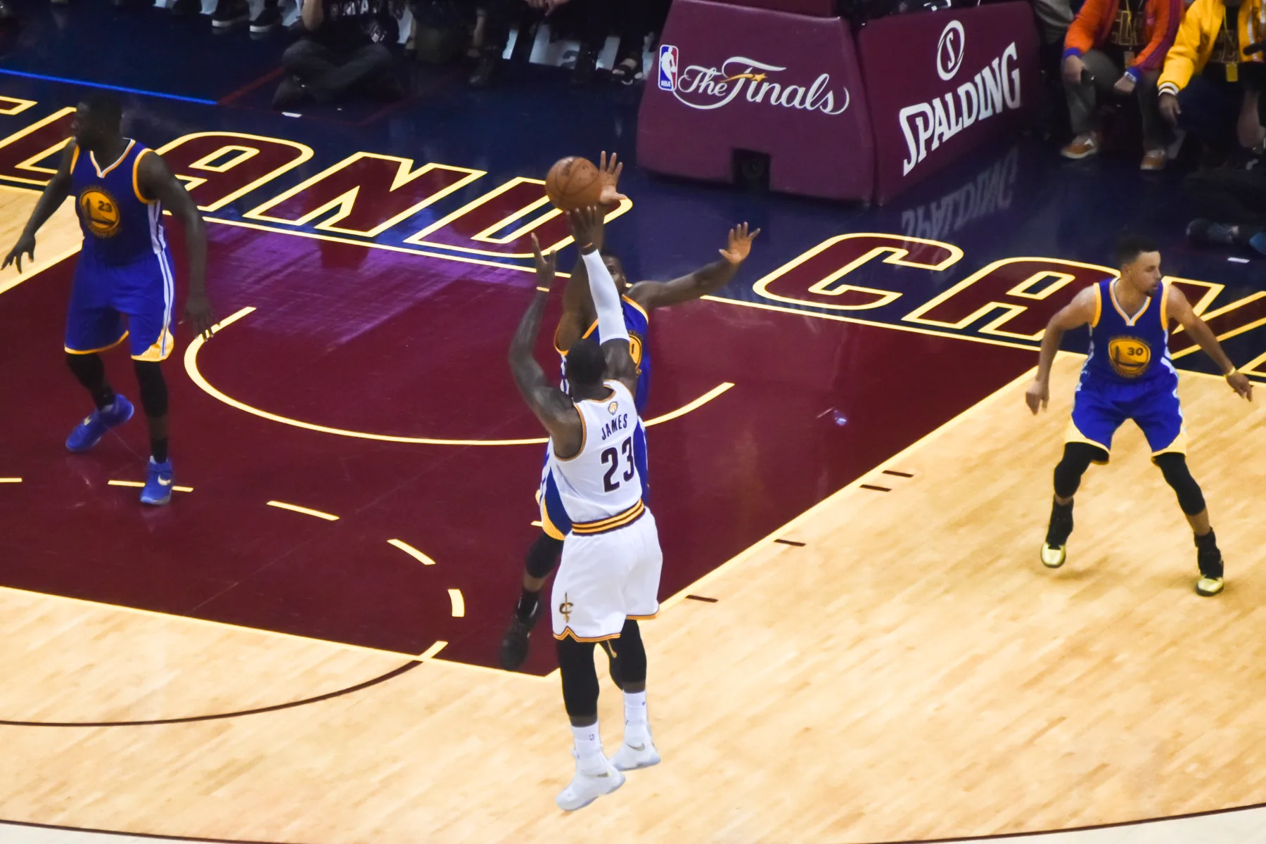 LeBron James shooting over Andre Iguodala while Stephen Curry watches during Game 6 of the 2016 NBA Finals.